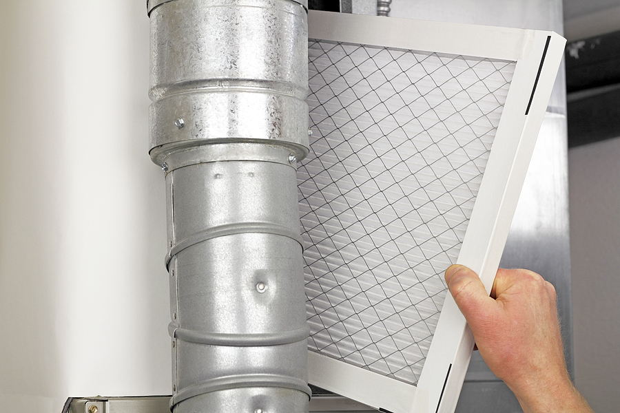 Miami homeowner replacing the filter in their home air conditioner